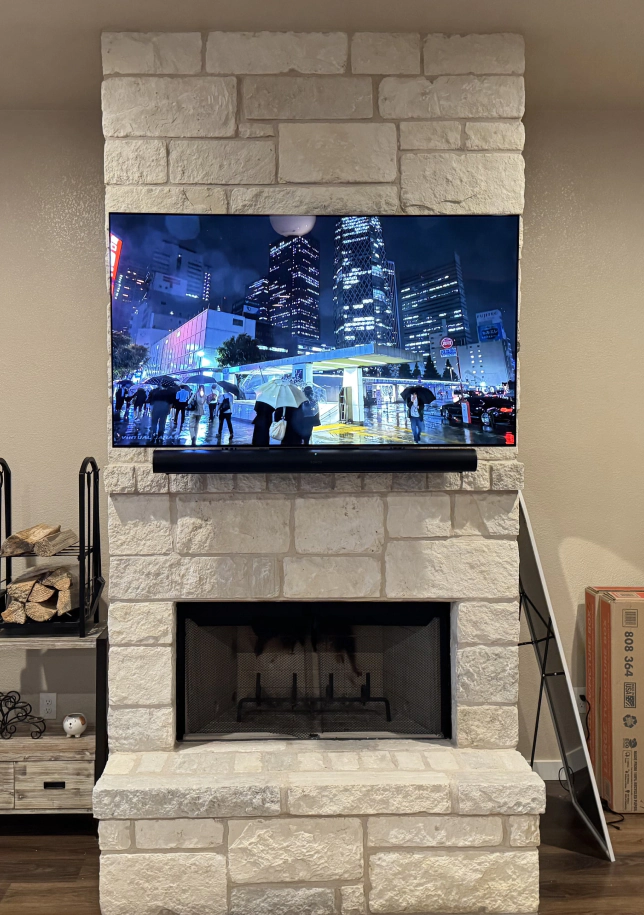 new TV mounted to brick wall